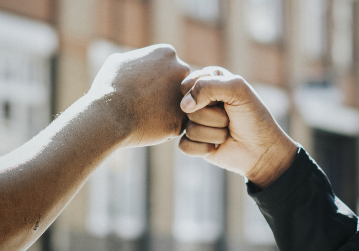 Two hands fist bumping