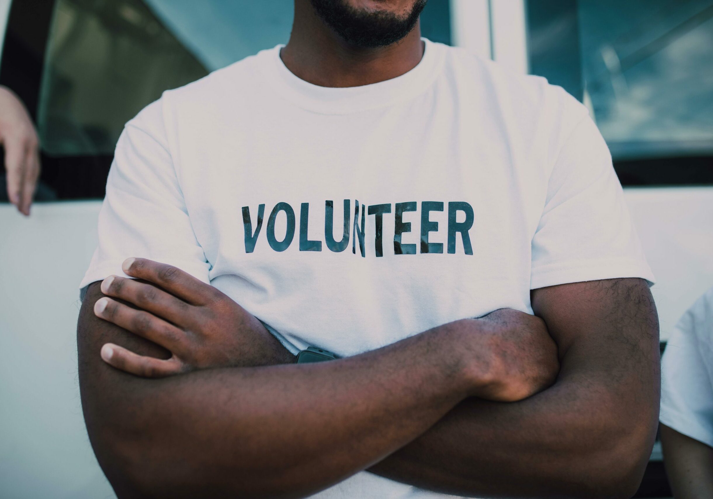 A volunteer with a shirt on that says 'Volunteer'